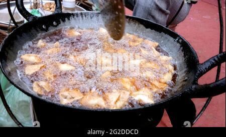 Frying vegetarian snack small samosa.Indian special traditional street food Stock Photo