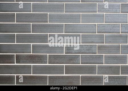 Background from a wall made of grey clinker bricks Stock Photo