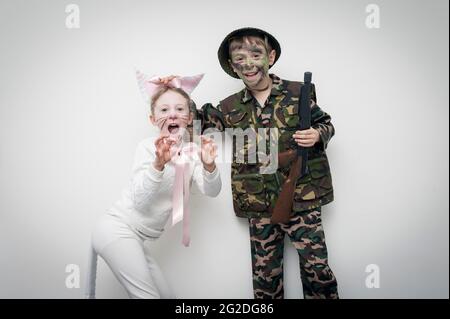 A child dressed up for world book day in a soldiers costume in front of a white wall Stock Photo
