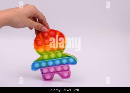 pop it color silicone toy in the form of a man. Stock Photo