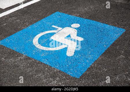 Handicapped symbol painted on asphalt. Traffic sign Stock Photo