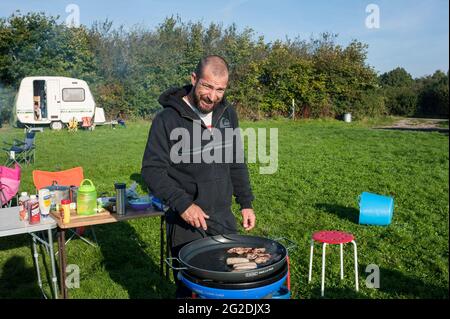 Family and friends enjoying a caravan and camping staycation trip Stock Photo