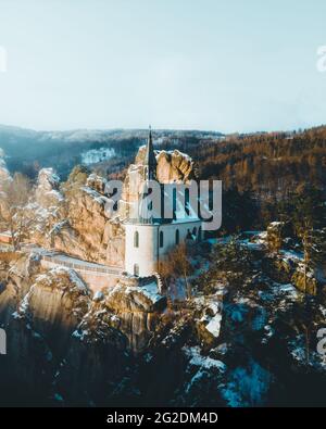 Ruins of Vranov Castle with small rock chapel, Pantheon, in Mala Skala on sunny winter day with blue sky and sunset light, Bohemian Paradise, alias Stock Photo