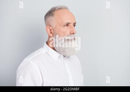 Profile side photo of elderly confident man look empty space concentrated focused isolated over grey color background Stock Photo