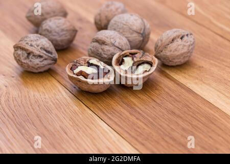 Stack Walnuts on wooden background. Walnut kernels close-up. Stock Photo