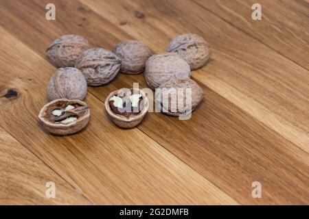 Stack Walnuts on wooden background. Walnut kernels close-up. Stock Photo