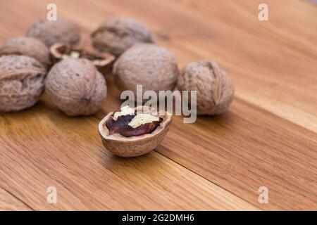 Stack Walnuts on wooden background. Walnut kernels close-up. Stock Photo