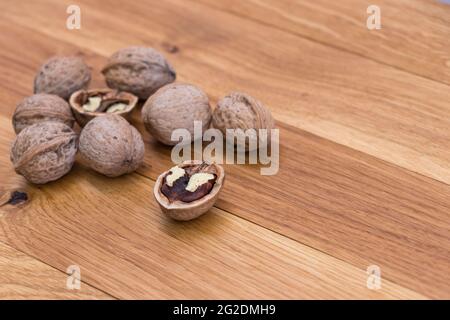 Stack Walnuts on wooden background. Walnut kernels close-up. Stock Photo