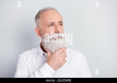 Photo of dreamy old man look empty spade hold hand beard imagine idea plan isolated on grey color background Stock Photo