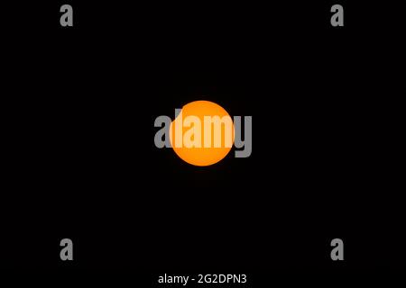 Beautiful centered view of partial (annular) eclipse visible in Irish skies on June 10, 2021, Dublin, Ireland. The end phase Stock Photo