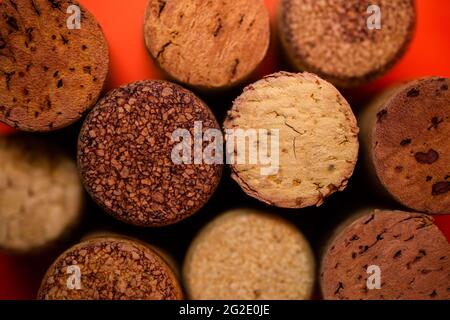 Cork from wine of different kinds on a red background view from above. Stock Photo