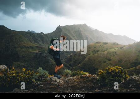 Man hiker exploring mountains of Tenerife Travel healthy lifestyle adventure trip hiking solo with backpack active vacations outdoor Stock Photo
