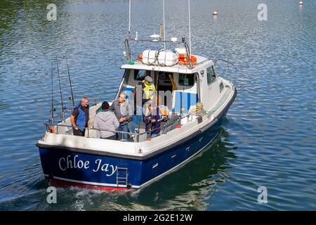 Anglers on sea fishing trip on hired boat Stock Photo