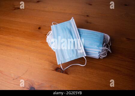 A stack of medical face masks to prevent Coronavirus.Healthcare medical Coronavirus quarantine. Disposable surgical face mask to cover mouth and nose. Stock Photo