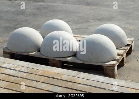 Blocks of movement of cars in the pedestrian zone. The concrete blocks are awaiting installation. Parking restrictor of vehicle passage. Concrete sphe Stock Photo