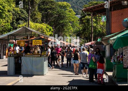 Crowds of people browsing items in Alto Fair tents, a public market located in the surroundings of Higino da Silveira square, Alto district. Stock Photo