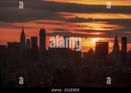June 10, 2021 partial solar eclipse over NYC skyline at sunrise Stock Photo