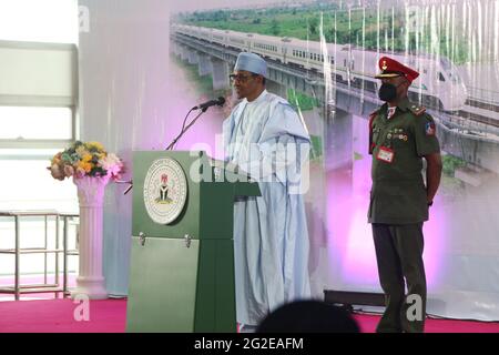 Lagos. 10th June, 2021. Nigerian President Muhammadu Buhari speaks at a ceremony to flag off the commercial operation of the Lagos-Ibadan railway at the Mobolaji Johnson Railway Station in Lagos, Nigeria on June 10, 2021. Nigeria on Thursday officially started the full commercial operation of a China-assisted railway linking the southwestern cities of Lagos and Ibadan, to ease public transportation and fuel goods movement in the west African country.TO GO WITH 'Roundup: Nigeria flags off full commercial operation of China-assisted railway' Credit: Emma Houston/Xinhua/Alamy Live News Stock Photo