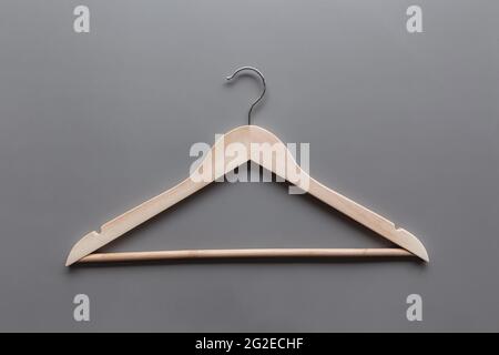 Black Friday or clothing industry concept on gray background flat lay with single one isolated wooden clothes hanger Stock Photo