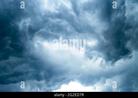Thick dark black storm clouds covering summer sunset sky with gale-speed wind blowing just before Nor'westers Kalbaishakhi Bordoisila thunderstorm tor Stock Photo