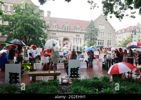 Bloomington, US. 10th June 2021. Stephanie Deemer of The IU Family for Choice, Not Mandates, speaks in the rain.Anti-vaxxers and anti-maskers gathered at Indiana University's Sample Gates to protest against mandatory Covid vaccinations IU is requiring for students, staff and faculty during the upcoming fall semester. The protesters say their constitutional rights are being infringed, and have launched a law suit. Credit: SOPA Images Limited/Alamy Live News Stock Photo