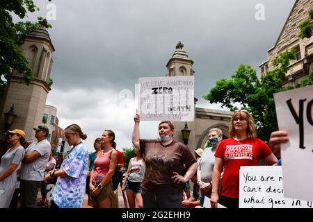 Bloomington, US. 10th June 2021. Protesters gather at Indiana University's Sample Gates during the demonstration.Anti-vaxxers and anti-maskers gathered at Indiana University's Sample Gates to protest against mandatory Covid vaccinations IU is requiring for students, staff and faculty during the upcoming fall semester. The protesters say their constitutional rights are being infringed, and have launched a law suit. Credit: SOPA Images Limited/Alamy Live News Stock Photo