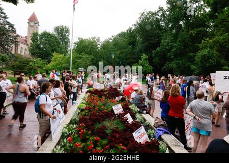 Bloomington, US. 10th June 2021. Protesters gather at Indiana University's Sample Gates during the demonstration.Anti-vaxxers and anti-maskers gathered at Indiana University's Sample Gates to protest against mandatory Covid vaccinations IU is requiring for students, staff and faculty during the upcoming fall semester. The protesters say their constitutional rights are being infringed, and have launched a law suit. Credit: SOPA Images Limited/Alamy Live News Stock Photo