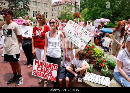 Bloomington, US. 10th June 2021. Protesters holding placards gather at Indiana University's Sample Gates during the demonstration.Anti-vaxxers and anti-maskers gathered at Indiana University's Sample Gates to protest against mandatory Covid vaccinations IU is requiring for students, staff and faculty during the upcoming fall semester. The protesters say their constitutional rights are being infringed, and have launched a law suit. Credit: SOPA Images Limited/Alamy Live News Stock Photo