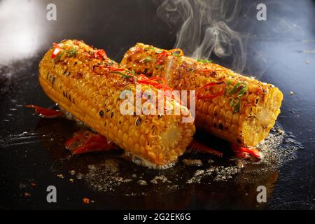 High angle of delicious corn cobs preparing in oil on hot surface in kitchen Stock Photo