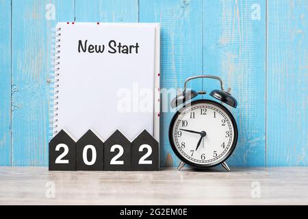 2022 Happy New Year with New start, black retro alarm clock and wooden number.Resolution, Goals, Plan, Action and Mission Concept Stock Photo