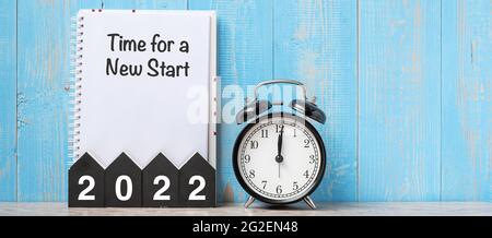 2022 Happy New Year with Time for a New start, black retro alarm clock and wooden number.Resolution, Goals, Plan, Action and Mission Concept Stock Photo