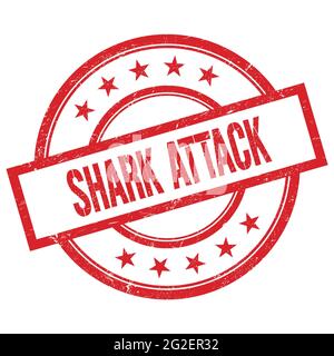 SHARK ATTACK text written on red round vintage rubber stamp. Stock Photo