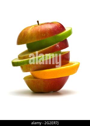 slices of pear, green apple, orange, stacked between sliced red apple, isolated on white Stock Photo