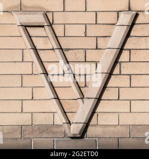 Large letter V composed of light clinker Stock Photo