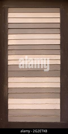 Old shutter with slats, painted in different shades of brown Stock Photo