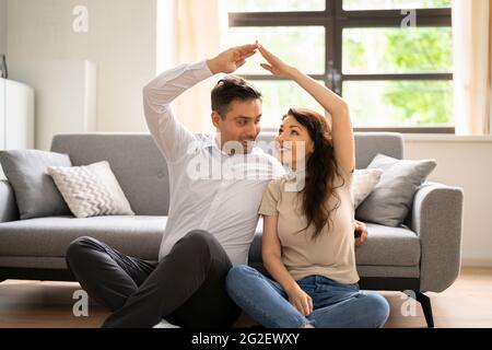 Couple Dreaming And Think To Buy House. Family Plans Stock Photo