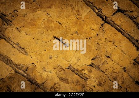 texture or background of old destroyed clay wall with wood inserts Stock Photo