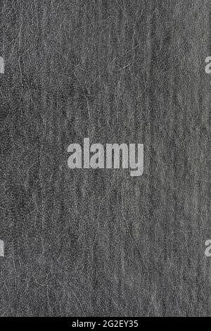 Synthetic dark gray, black leather for background. Close-up vertical macro photography of texture decoration material, pattern background. Stock Photo