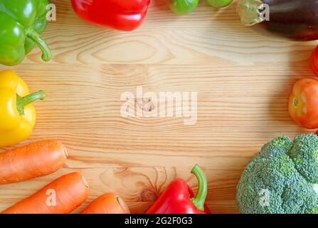 Frame of colorful assorted fresh vegetables on wooden backdrop with copy space Stock Photo