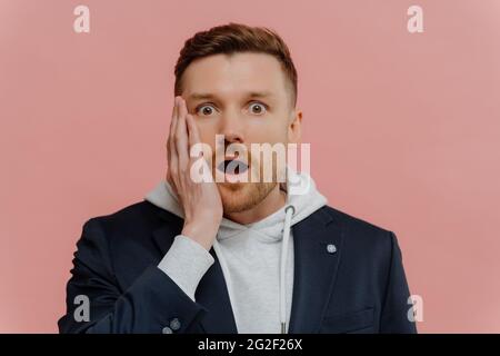 Impressed guy getting some awesome news and being in shock Stock Photo