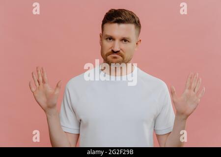 Young unhappy man refusing proposition and showing denial sign Stock Photo