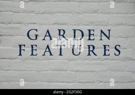 garden features wording painted on grey brick wall, norfolk, england Stock Photo