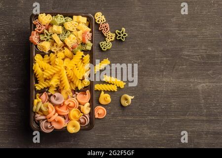 Different types of raw pasta in a box on the table Stock Photo