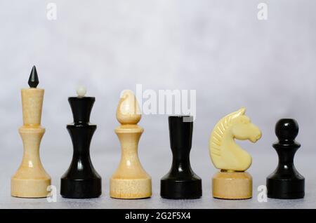 Side view of black and white chess pieces on a chessboard Stock Photo