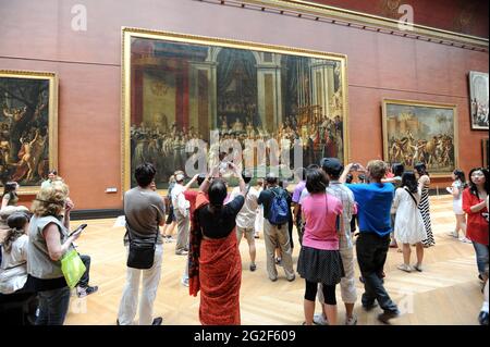 The Louvre art gallery Paris France. French arts painting paintings exhibition tourists visitors people visiting europe european tourism culture Stock Photo