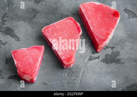 Raw frozen tuna fish fillet set, on gray stone background Stock Photo