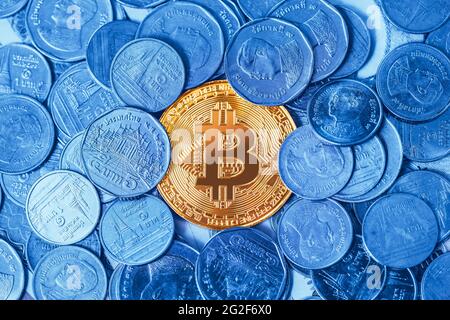 Bitcoin crypto digital currency around with physical coin money Thai Bath. Stock Photo