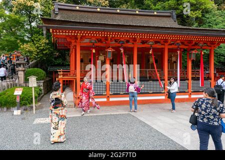 Kyoto, Japan - 15.05.2019: Women in traditional kimono in the complex of world famous Fushimi Inari Shrine in Kyoto on a cloudy day. Classical Japanes Stock Photo