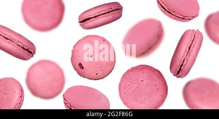 Pink Macarons. French Dessert, Selective Focus. Falling Macaroons isolated on White Background Stock Photo