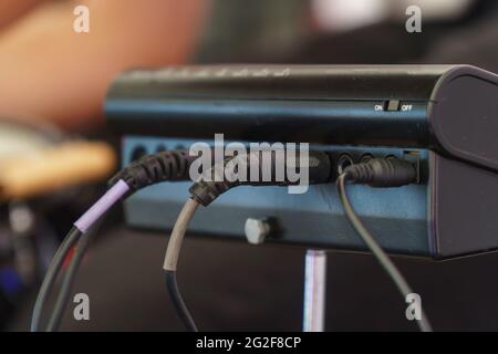 The wires are in a small mixing console. Rear view. Selective Focus Stock Photo